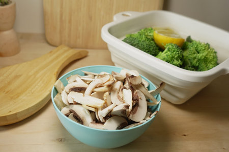 Mushrooms and broccoli chopped for cookingの写真素材