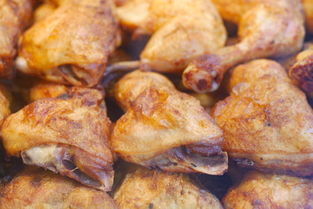 Crispy fried chicken pieces at a lively food marketの写真素材