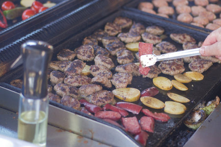Grilling meat and vegetables at a summer barbecue gathering