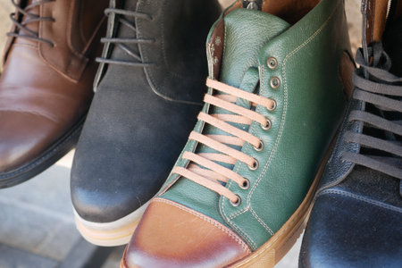 Various styles of shoes displayed for purchase in a shopの写真素材