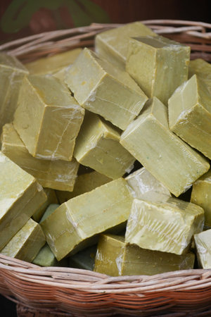 Green soap bars displayed in a woven basketの写真素材
