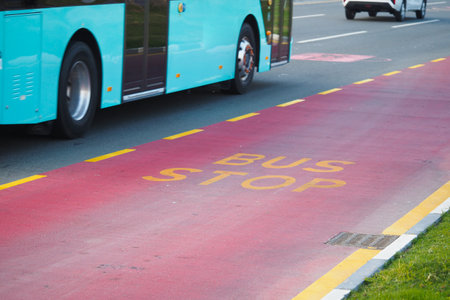 City bus stop and transit lane during daytimeの写真素材