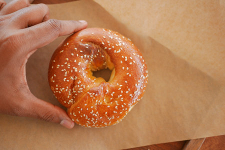 Freshly baked bagel on parchment paper