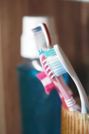Toothbrushes and mouthwash on a bathroom counterの写真素材