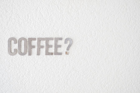 Coffee sign on a white wall in a cafe settingの写真素材