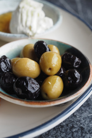 Fresh green and black olives served in small bowlの写真素材