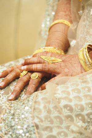 Gold jewelry on elegant hands at a weddingの写真素材