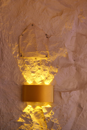 Elegant wall lighting casts warm glow in cozy interior spaceの写真素材