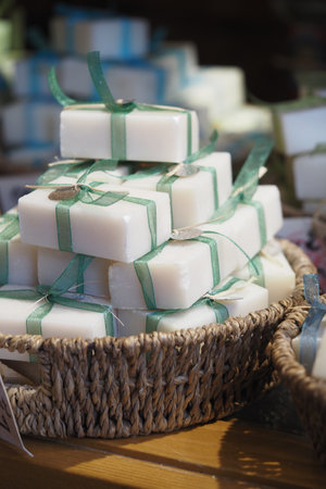 Handcrafted natural soaps arranged in a rustic basketの写真素材