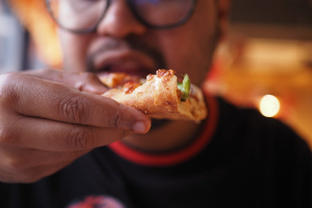 Enjoying a slice of pizza at a cozy restaurant