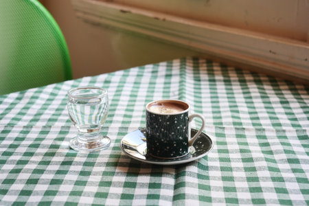 turkish Coffee served in a traditional cup on a checkered tableの写真素材