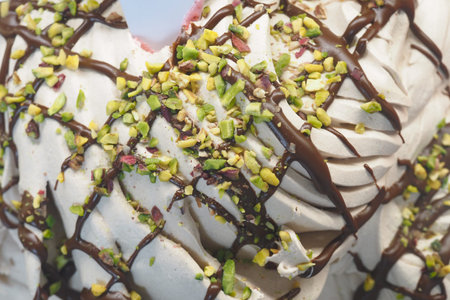 Delicious ice cream topped with chocolate and pistachios