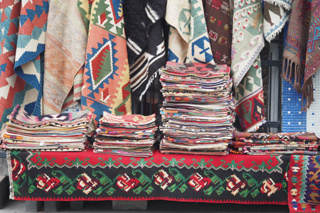Woven textiles displayed for sale at a marketの写真素材
