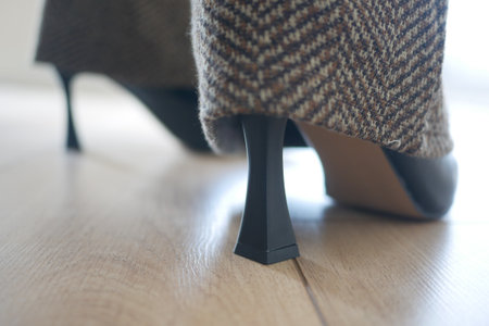 Stylish high heel shoes on wooden floor in natural lightの写真素材