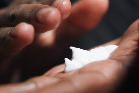 Applying moisturizer to dry hands during skincare routine