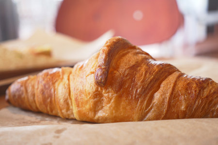 Freshly baked croissant on a wooden tableの写真素材
