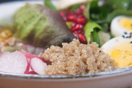 Healthy bowl of quinoa and fresh vegetables on a plateの写真素材