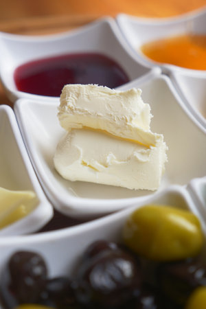 Delicious spread with fresh butter and assorted condimentsの写真素材