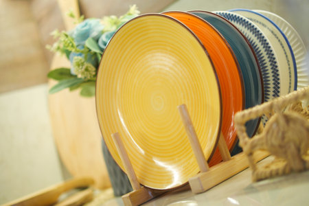 Colorful plates displayed in a cozy dining spaceの写真素材