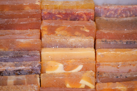 Colorful handmade soaps displayed at a local marketの写真素材