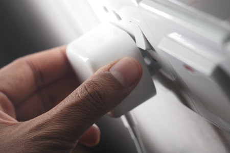 Hand adjusting power plug in modern electrical outletの写真素材