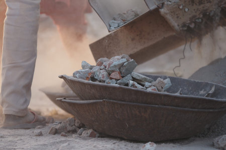 Construction worker loading materials for a building projectの写真素材