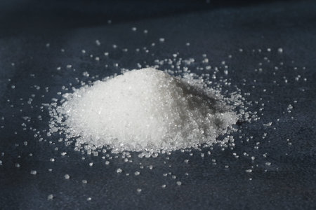 White sugar pile on dark surface