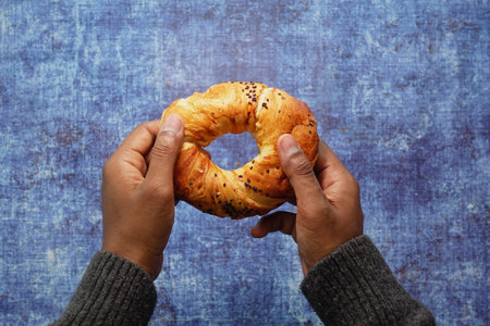 Enjoying a freshly baked croissant with sesame seeds