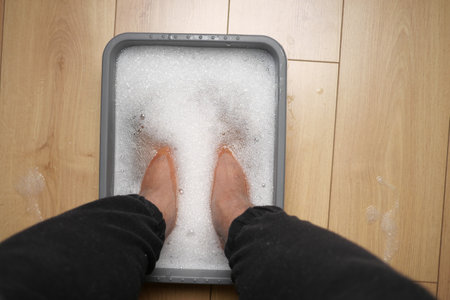 Relaxing foot soak in a bubbly tub at homeの写真素材
