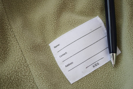 Label on kids garment with pen on soft fabric surface