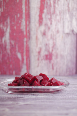 Freshly cut beetroot cubes on a glass plate