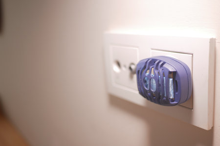 an electric mosquito repellent plugged into a wall socketの写真素材