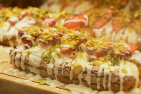 Delicious pastry topped with strawberries and nutsの写真素材