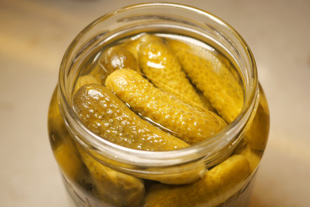 Cucumbers preserved in glass jar for fresh picklingの写真素材
