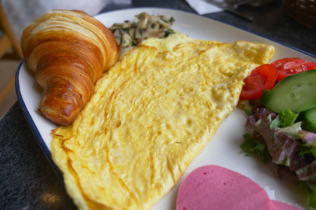 Breakfast plate: croissant and fresh veggies
