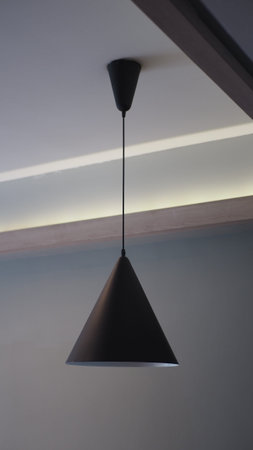 Modern pendant lamp illuminating a minimalist spaceの写真素材