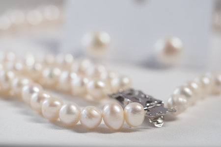 Pearl necklace and earrings on a soft surfaceの写真素材