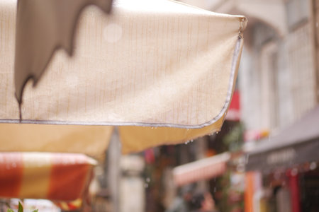 Patio with umbrellas for light rain dining in the cityの写真素材