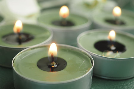 Decorative candles glowing in a peaceful settingの写真素材