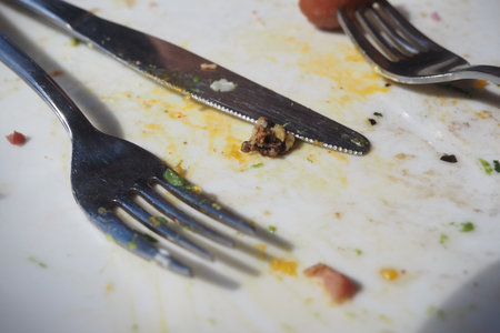 Table set with utensils and meal leftoversの写真素材