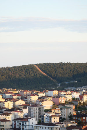 Sunrise over residential area with hills in backgroundの写真素材