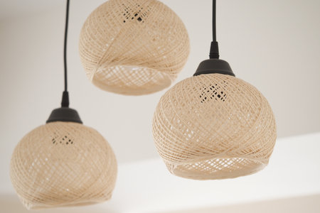 Hanging woven lamps brighten modern indoor spaceの写真素材