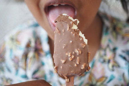 Enjoying a chocolate ice cream treat on a warm dayの写真素材