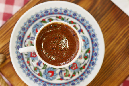 top view of turkish coffee served in decorative cup on wooden tableの写真素材