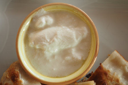 Delicious yogurt served with crispy bread on a plateの写真素材