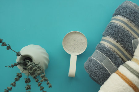 Soft towels and washing power on a color backgroundの写真素材