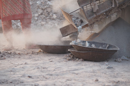 Construction worker using tools at building site dustの写真素材