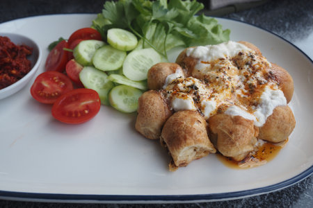Delicious Turkish style yogurtlu pide with fresh vegetablesの写真素材