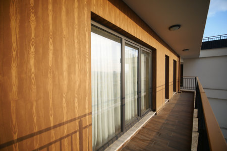 Bright balcony with wooden walls in modern buildingの写真素材