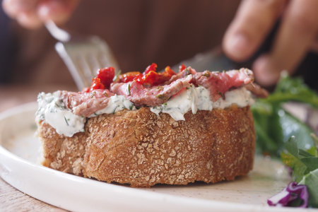 Delicious open-faced sandwich with fresh toppingsの写真素材